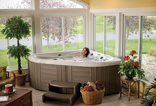 Triangular hot tub installed indoors